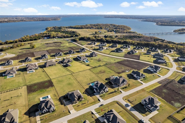 drone / aerial view with a water view and a residential view