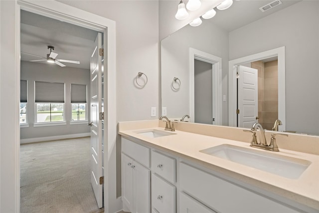 bathroom with baseboards, a ceiling fan, visible vents, and a sink