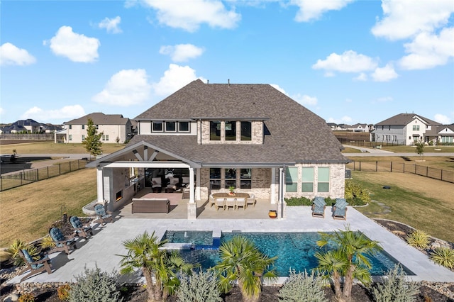 back of house with an outdoor living space, a patio, a fenced backyard, a yard, and a shingled roof