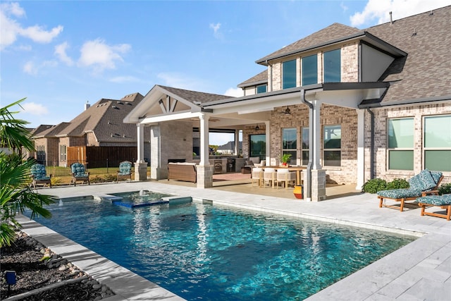 view of swimming pool featuring a patio area, fence, a pool with connected hot tub, and ceiling fan