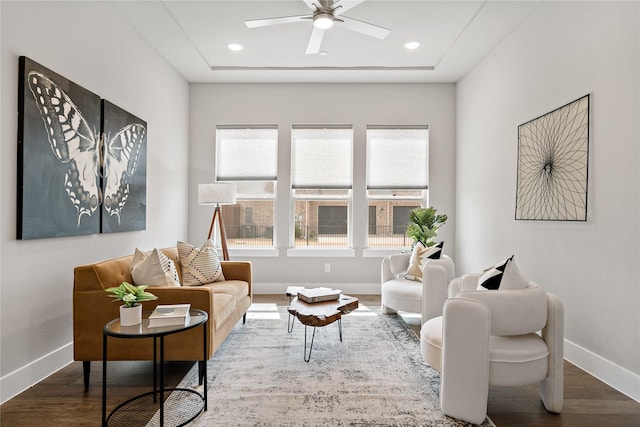 living area featuring a wealth of natural light, baseboards, and wood finished floors