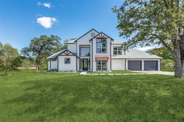 tudor-style house with a garage and a front yard