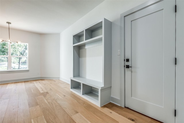 mudroom with a chandelier and light hardwood / wood-style floors