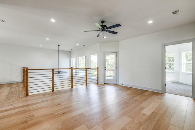 empty room featuring ceiling fan and light hardwood / wood-style floors