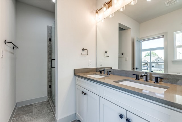 bathroom featuring vanity and a shower with door