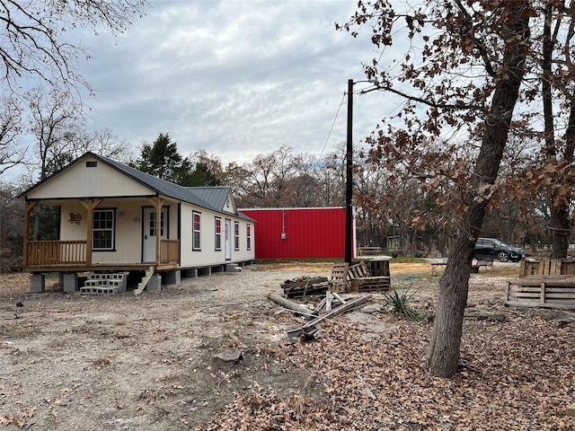 exterior space with metal roof and a porch