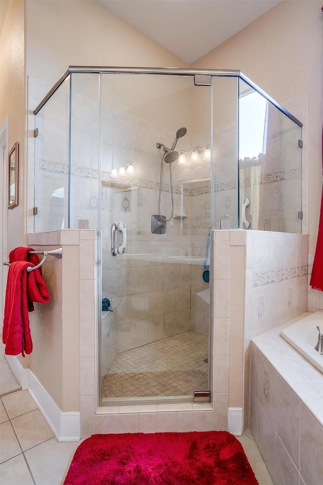 bathroom with lofted ceiling, tile patterned floors, and separate shower and tub