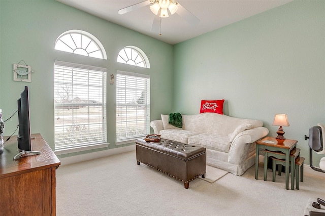 living room with light colored carpet and ceiling fan