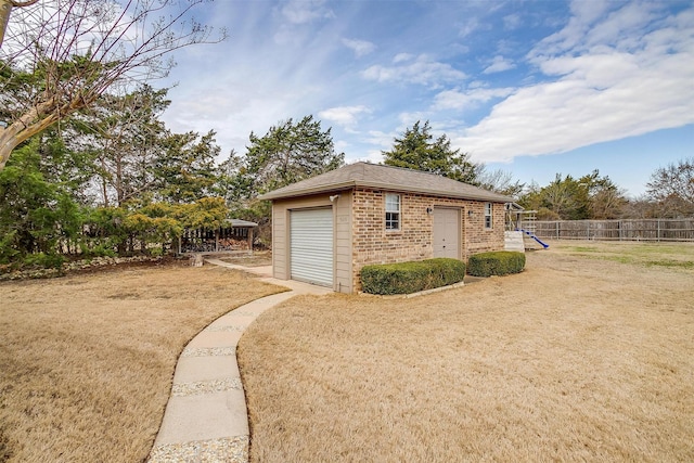 view of home's exterior featuring a garage, an outdoor structure, and a playground