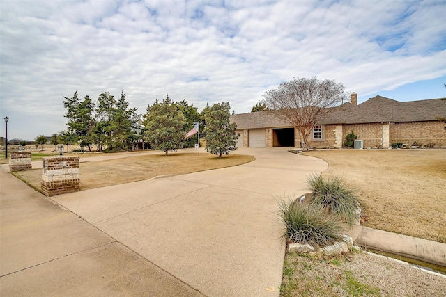 view of front of property featuring a garage and a front lawn