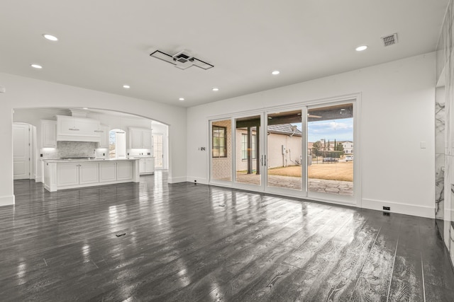 unfurnished living room featuring dark hardwood / wood-style floors