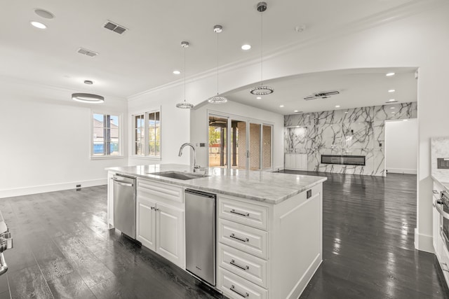 kitchen featuring pendant lighting, sink, white cabinetry, and stainless steel dishwasher