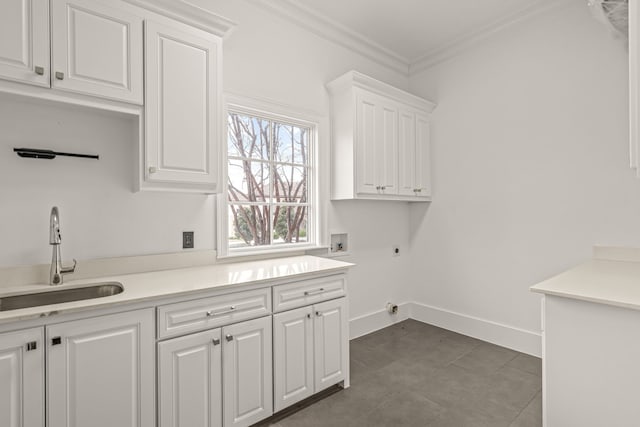 laundry area featuring sink, cabinets, ornamental molding, washer hookup, and electric dryer hookup