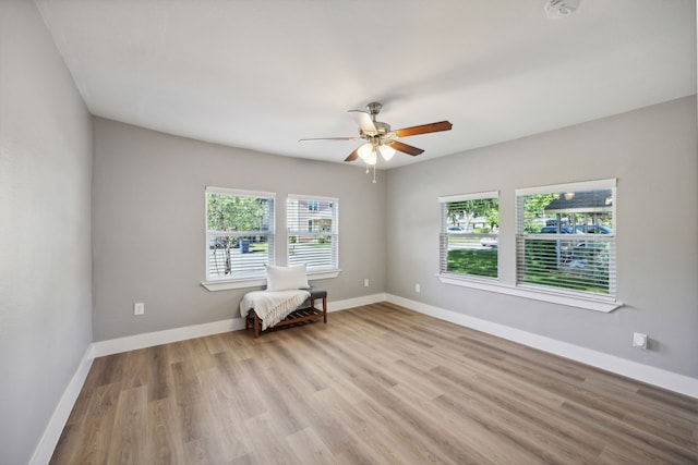 empty room with light hardwood / wood-style floors and ceiling fan