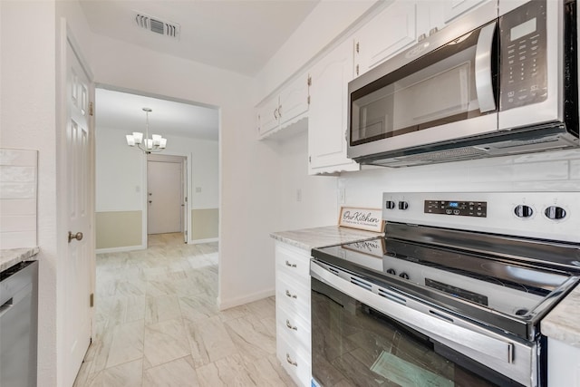 kitchen with pendant lighting, stainless steel appliances, light stone counters, white cabinets, and a chandelier