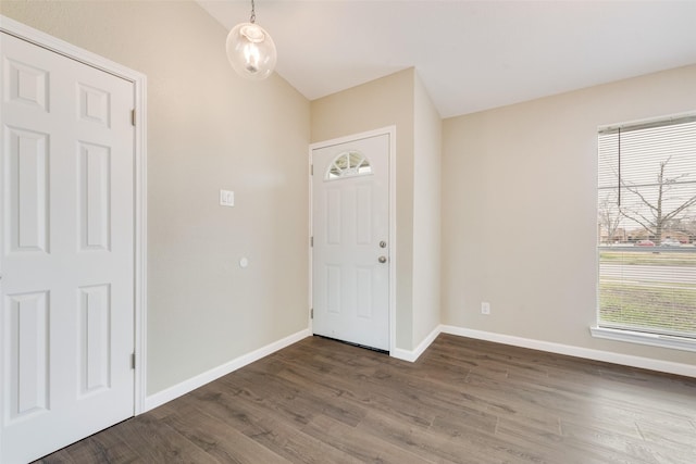 foyer entrance with dark hardwood / wood-style flooring and vaulted ceiling