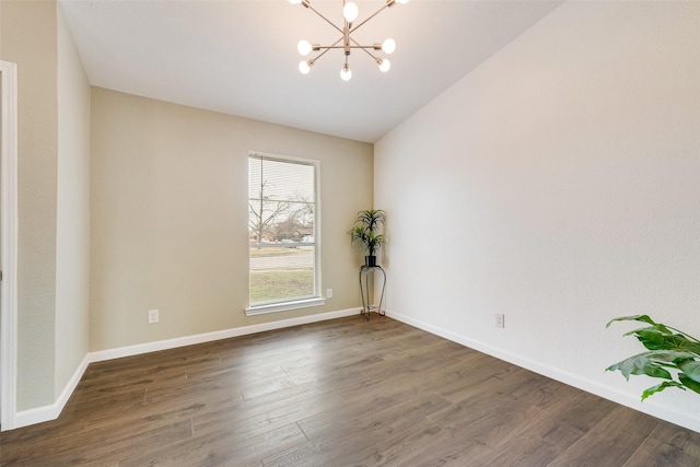 unfurnished room featuring an inviting chandelier, dark hardwood / wood-style flooring, and lofted ceiling