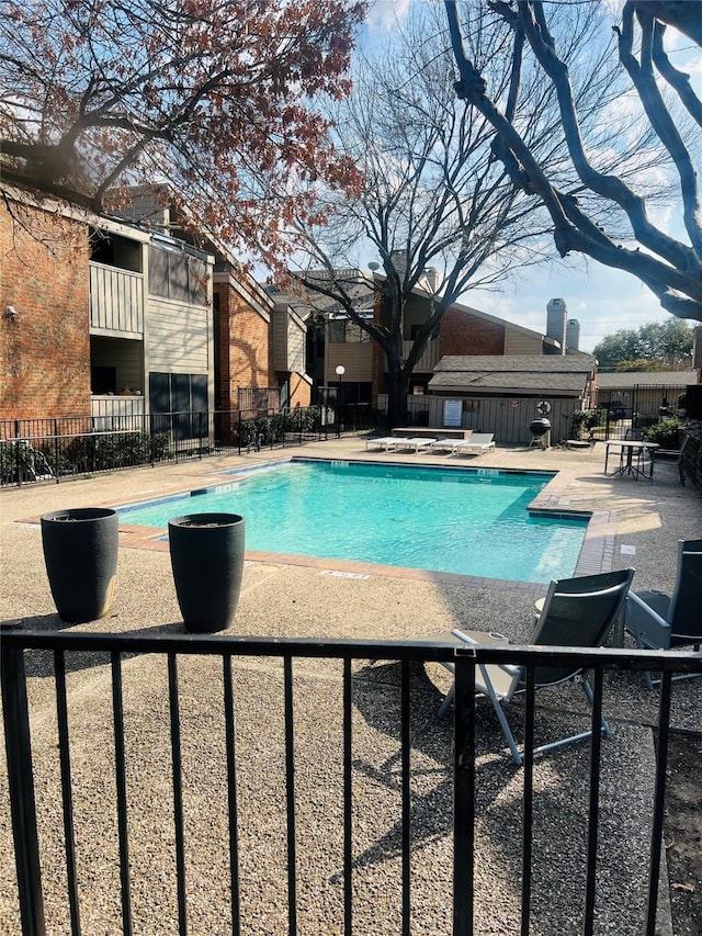 view of pool featuring a hot tub and a patio