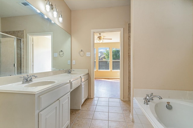 bathroom featuring vanity, tiled bath, and tile patterned flooring