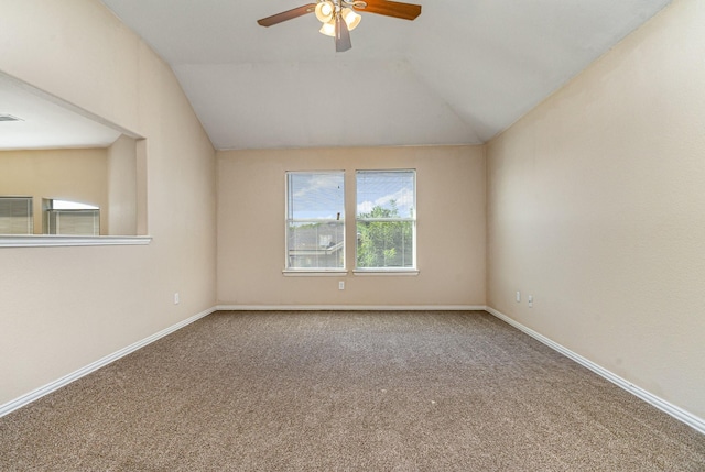 empty room with lofted ceiling, ceiling fan, and carpet