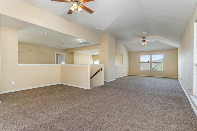 carpeted spare room with vaulted ceiling