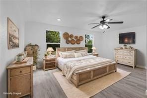 bedroom with ceiling fan and light hardwood / wood-style flooring