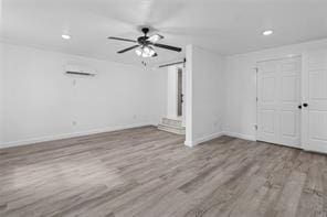 unfurnished living room featuring ceiling fan and light wood-type flooring