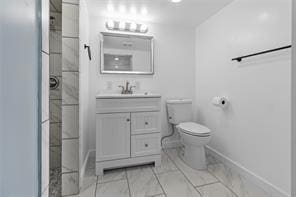 bathroom featuring walk in shower, vanity, and toilet