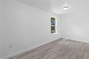 unfurnished room with light wood-type flooring