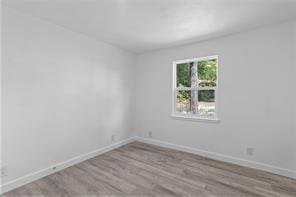 spare room with light wood-type flooring