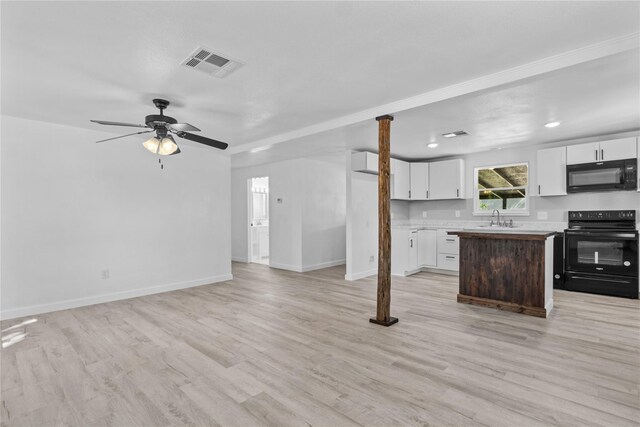 kitchen featuring a center island, sink, white cabinets, and black appliances