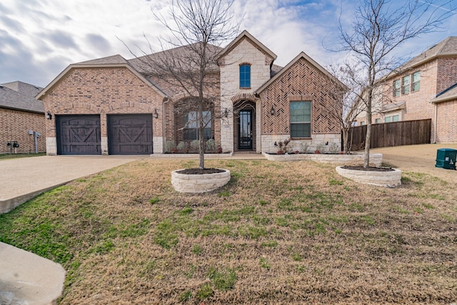 view of front of home with a garage and a front yard