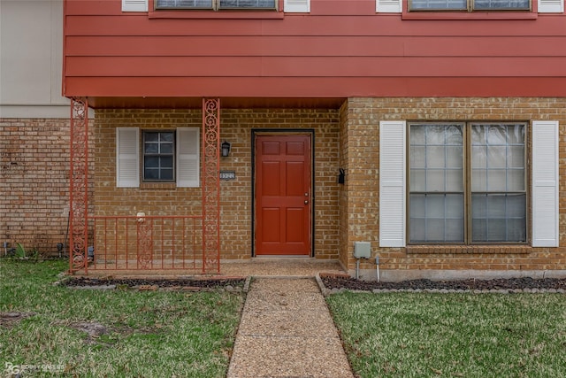 doorway to property featuring a yard