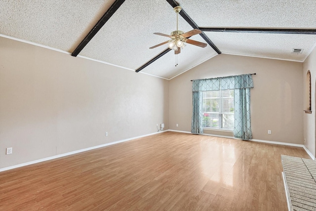 spare room with ceiling fan, light hardwood / wood-style flooring, a textured ceiling, and vaulted ceiling with beams