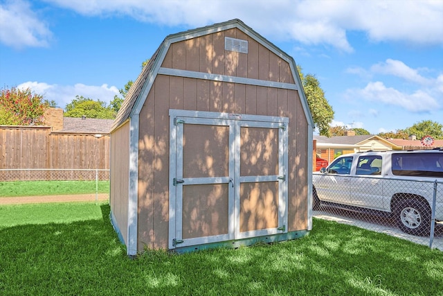 view of outdoor structure featuring a lawn