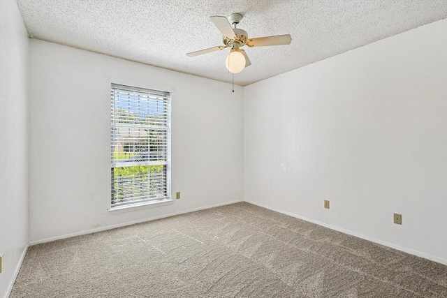 carpeted empty room featuring ceiling fan and a textured ceiling