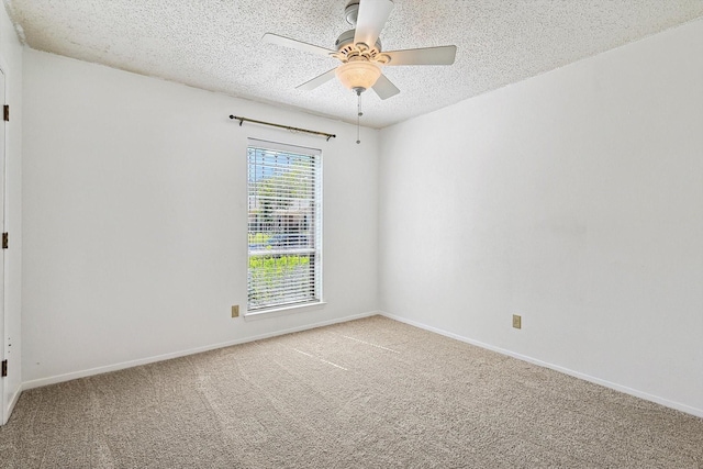 carpeted empty room featuring ceiling fan and a textured ceiling