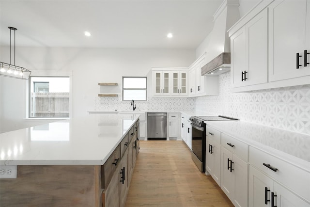 kitchen featuring white cabinets, dishwasher, custom range hood, and electric range