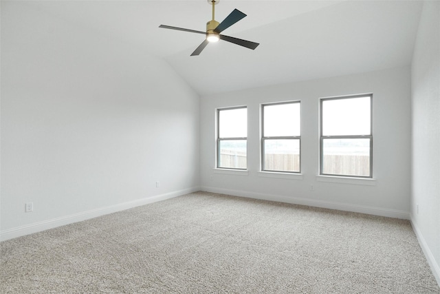 empty room with vaulted ceiling, carpet, and ceiling fan