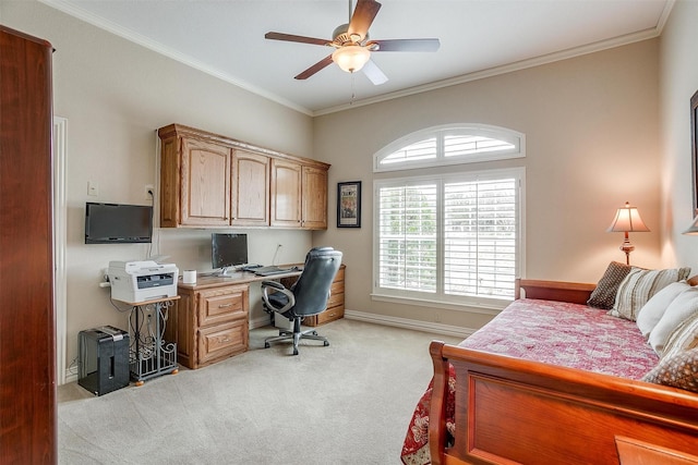 office with ceiling fan, light colored carpet, built in desk, baseboards, and ornamental molding