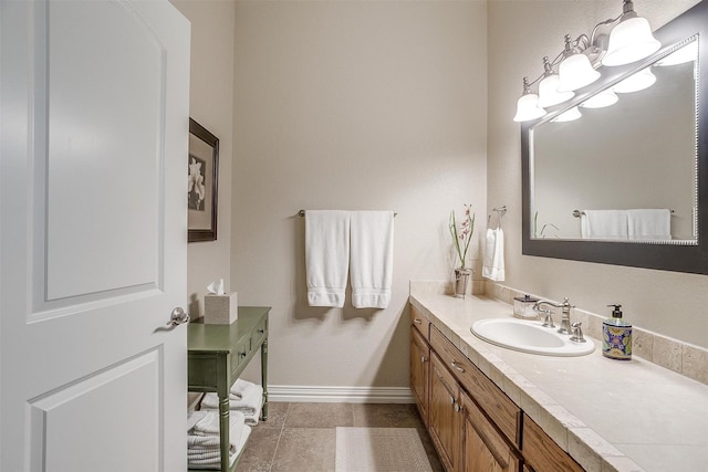bathroom featuring vanity, baseboards, and tile patterned floors