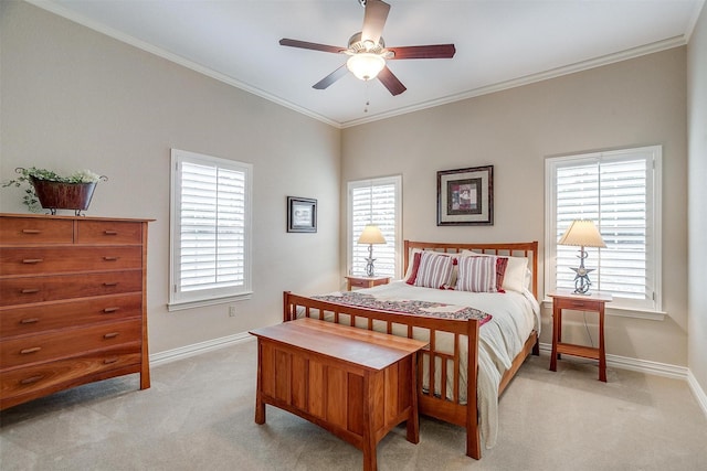 bedroom featuring baseboards, crown molding, light carpet, and ceiling fan