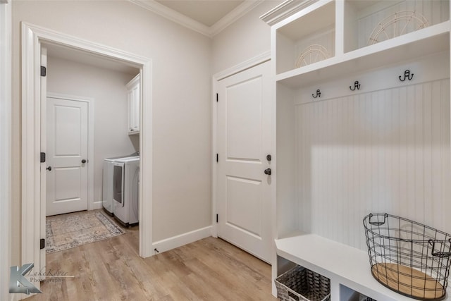 mudroom featuring light wood-type flooring, washer and dryer, and ornamental molding