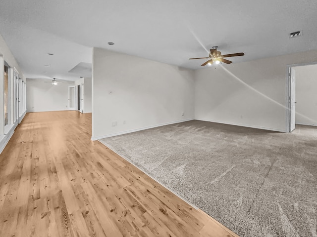 unfurnished living room with wood-type flooring and ceiling fan