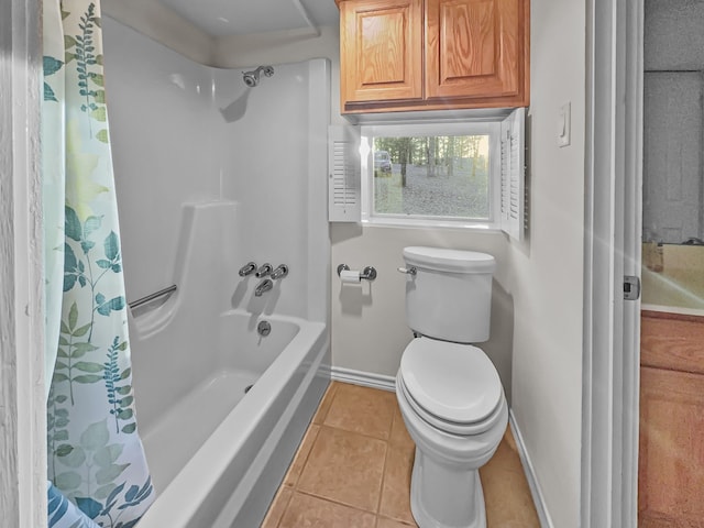 bathroom featuring shower / tub combo with curtain, tile patterned flooring, and toilet