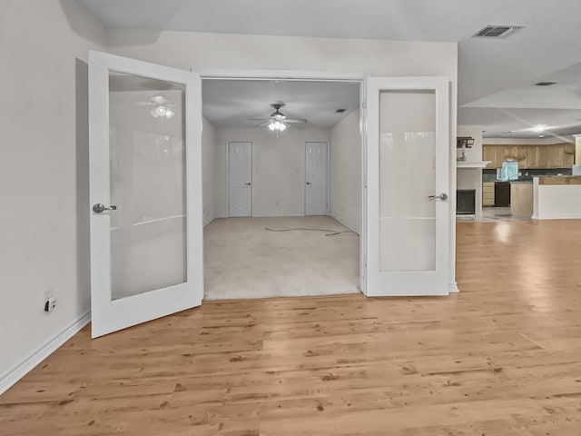 1476 W Holly Trl, Holly Lake Ranch, TX 75765 - interior space featuring light wood-style floors, ceiling fan, visible vents, baseboards, and french doors