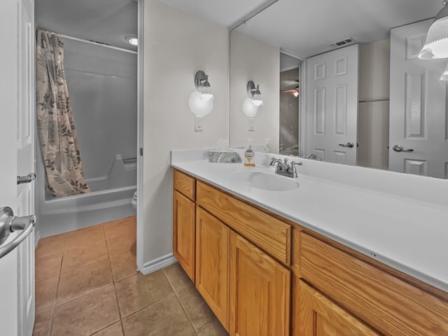 full bathroom featuring vanity, toilet, tile patterned floors, and shower / bath combo with shower curtain