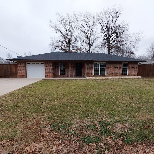 ranch-style home featuring a garage and a front yard