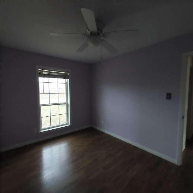 spare room with ceiling fan and dark hardwood / wood-style flooring