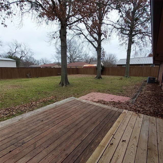 wooden deck featuring a yard and central air condition unit